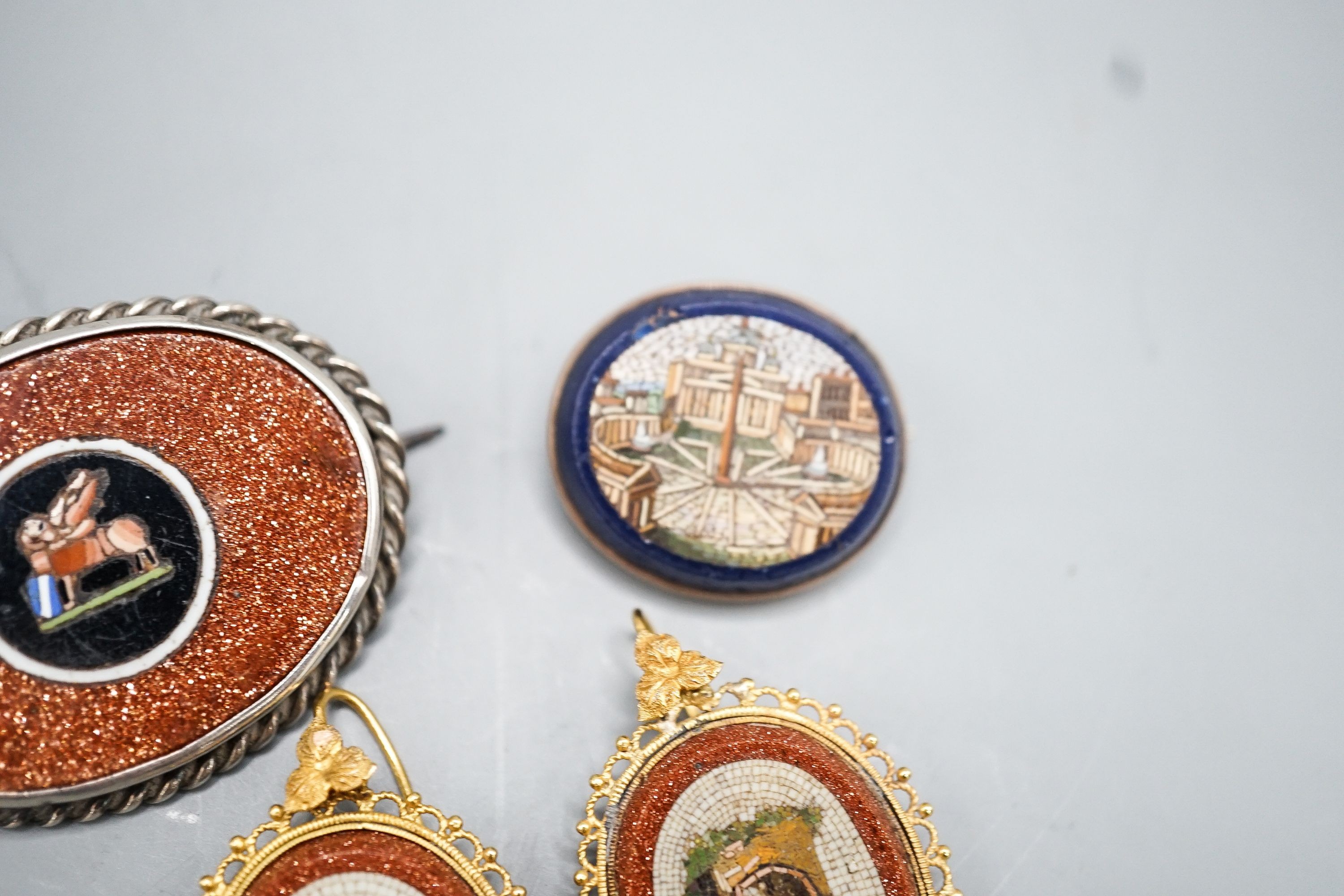 A pair of yellow metal mounted adventurine glass and micro mosaic oval earrings, decorated with ancient architecture, 32mm, a small micro mosaic oval brooch and a white metal mounted adventurine glass and micro mosaic ov